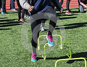 Speed work over yellow mini hurdles at practice