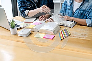 High school tutor or college student group sitting at desk in library studying and reading, doing homework and lesson practice