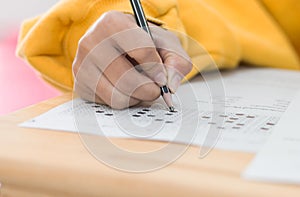 High school or university student hands taking exams, writing ex