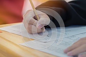 High school or university student hands taking exams, writing ex