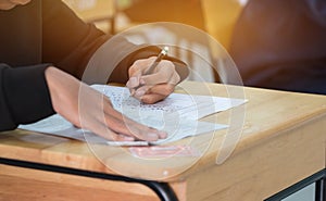 High school or university student hands taking exams, writing ex