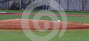 Pitchers mound with rosin bag on a turf infield photo