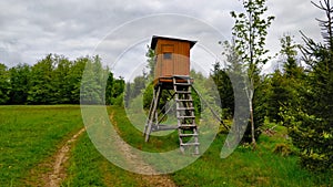 High seat by the road on the edge between meadow and forest