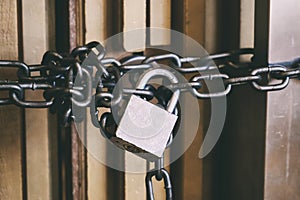 High Security Locked Door by Brass Padlock and Big Chain. Safety and Security Concept