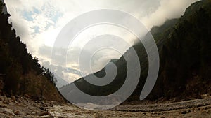 High sky and montains Himalaya river Ganges flows by impetuous stream clouds slowly move