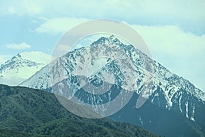 High snow-capped mountain of the Trans-Ili Alatau. Big Almaty peak on a spring day