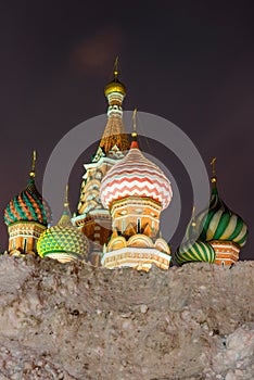a high snow drift and a view of the St. Basil`s Cathedral