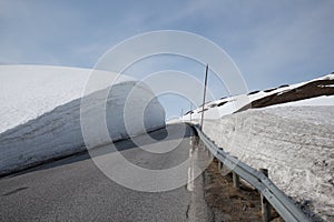 High snow wall along a mountain pass road Vikafjellet