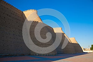 High solid brick walls of the Ark fortress in Bukhara in Uzbekistan. Tourism concept