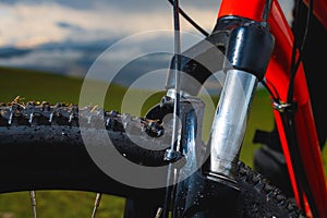 high-speed bicycle disc brake system, perforated disc and caliper, mtb, close-up, mountain bike brake efficiency