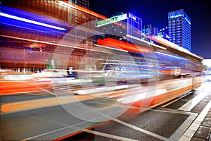 High speed and blurred bus light trails in downtown nightscape