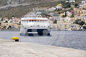 High Speed Catamaran Arriving in Main Port of Symi, Yialos, with Load of Tourists