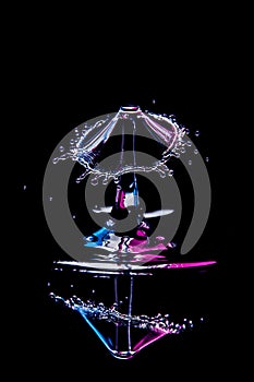 colored water drop on black background