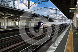High-speed electric train is running onto the platform of a small station in Fukushima city in Japan