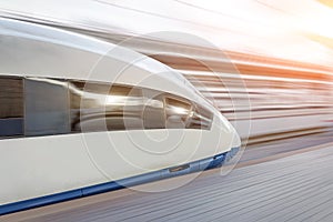 High speed fast train passenger locomotive in motion at the railway station.