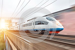 High speed fast train passenger locomotive in motion at the railway station city.