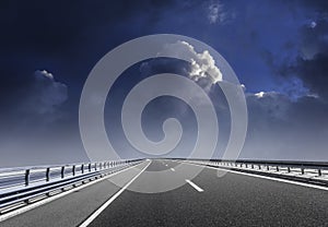 High-speed highway against the backdrop of an overcast sky.