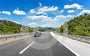 High-speed highway in mountainous terrain.