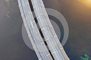 High-speed highway, with multilevel traffic road, the bridge across over the bay sea river. Aerial top view