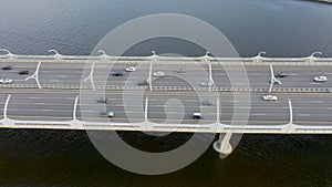 High-speed highway, with multilevel traffic road, the bridge across over the bay sea river. Aerial top view