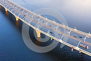 High-speed highway, turn traffic road, the bridge across over the bay sea river. Aerial top view