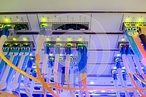 High-speed Internet connection to the master server is in a modern data center.  Many optical links are on the front panel of the