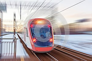 High speed modern commuter train red lights, motion blur