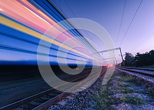 High speed passenger train in motion on the railroad at night