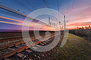 High speed passenger train in motion at sunset