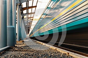 High speed passenger train on tracks with motion blur effect