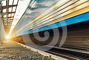 High speed passenger train on tracks with motion blur effect