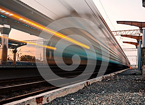 High speed passenger train on tracks with motion blur effect