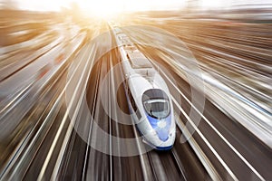 High-speed passenger train travels at high speed. Top view with motion effect, greased background.