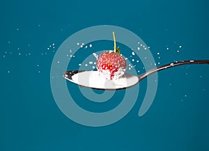 High-speed photo of strawberries falling into milk