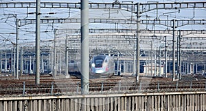 A high-speed rail train is leaving the station.