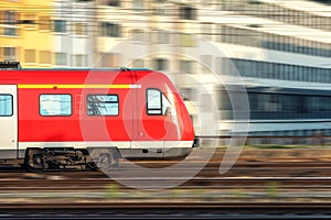 High speed red train in motion at sunset