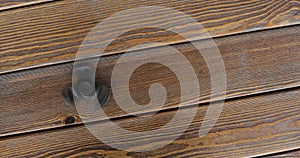 A high speed spinning hand spinner or fidget spinner over the wooden background.