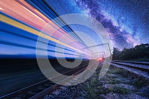 High speed train in motion and Milky Way at starry night