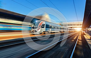 High speed train in motion at the railway station at sunset