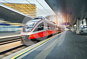 High speed train in motion on the railway station at sunset