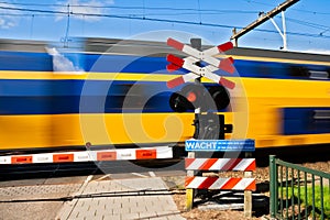 High speed train passing a railway crossing in The Netherlands