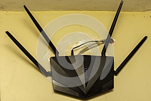 A high speed Wi-Fi router with antena hanging on a wall, Internet connection concept