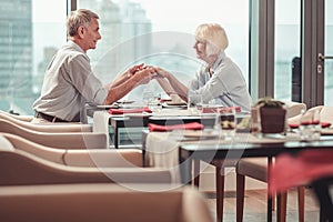 High-spirited retired couple having lunch in a restaurant