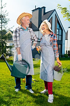 High-spirited retired couple spending a wonderful day in the garden