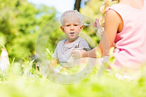 High-spirited small kid eating in the park