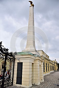 High square-section column with a golden eagle on top, with wings spread, in the Belvedere castle in Vienna.