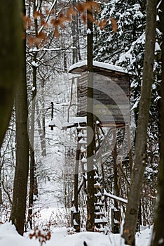 High stand for huntsmans, hunters and foresters in snowy winter forest