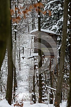 High stand for huntsmans, hunters and foresters in snowy winter forest