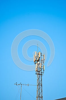 high steel radio tower against deep blue sky