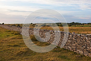 High stone wall in sunset